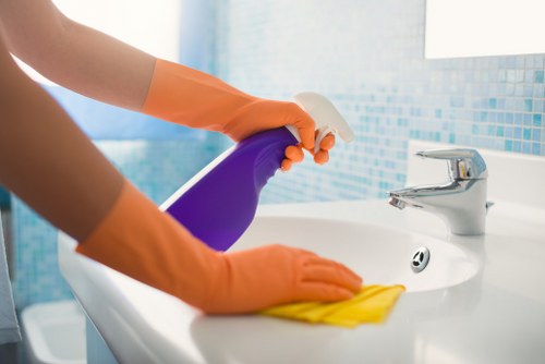 Technician cleaning carpets in a Croydon flat with practical access needs