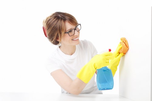 Technician treating upholstery stains on a fabric sofa in Croydon