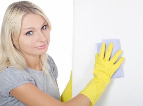 Professional cleaner preparing a kitchen and worktops in Croydon